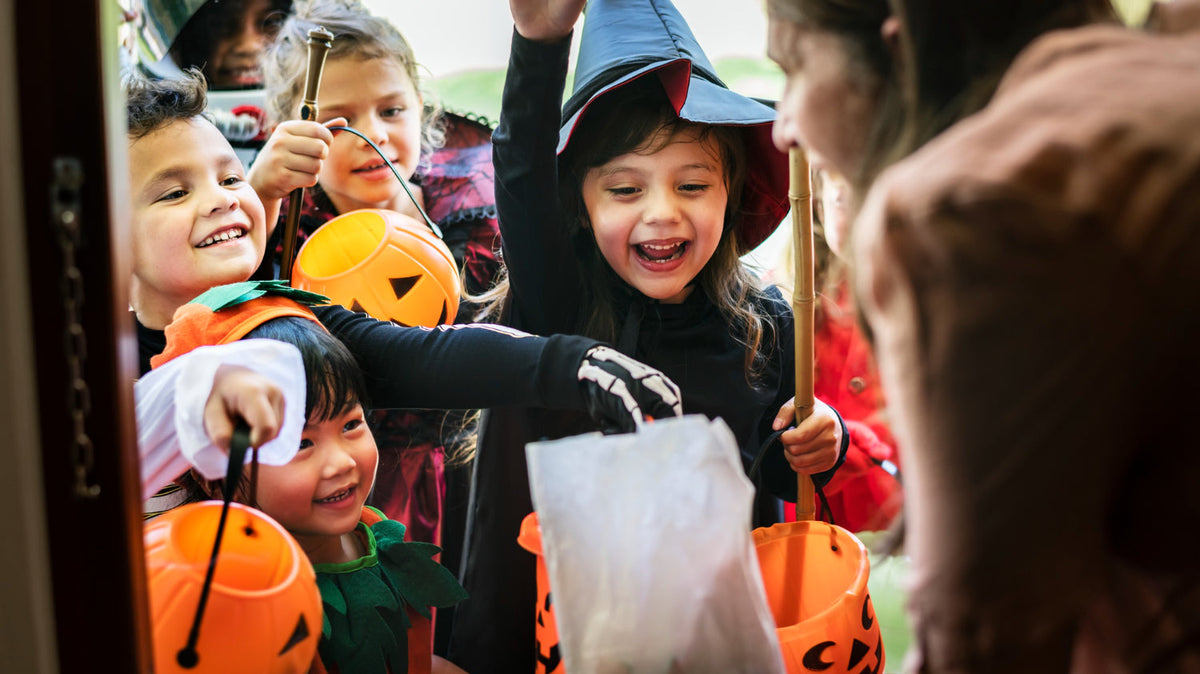 Kids in costume trick-or-treating.