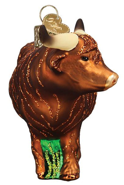 Brown glass Highland cow Christmas ornament with glittery fur texture, curved horns, and a gold hanging loop.