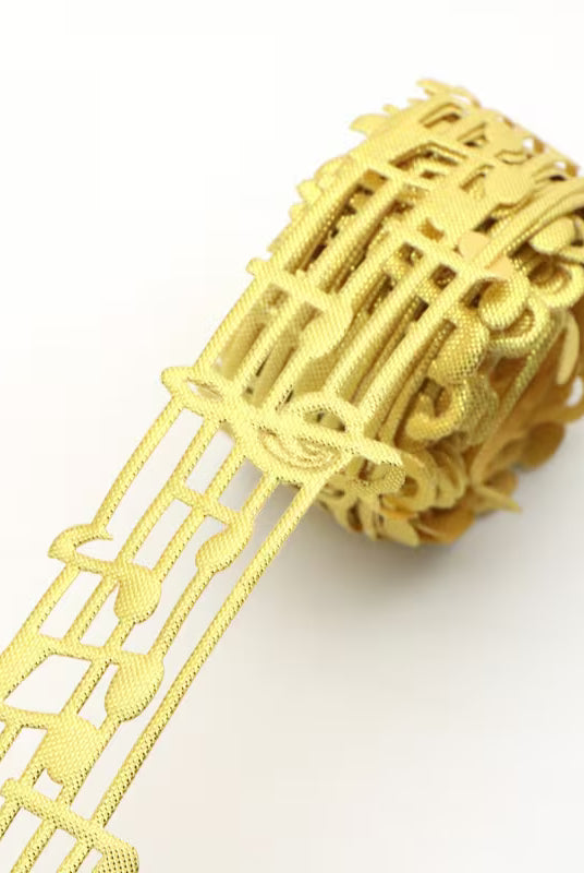 Close-up of gold non-wired music note lace ribbon texture