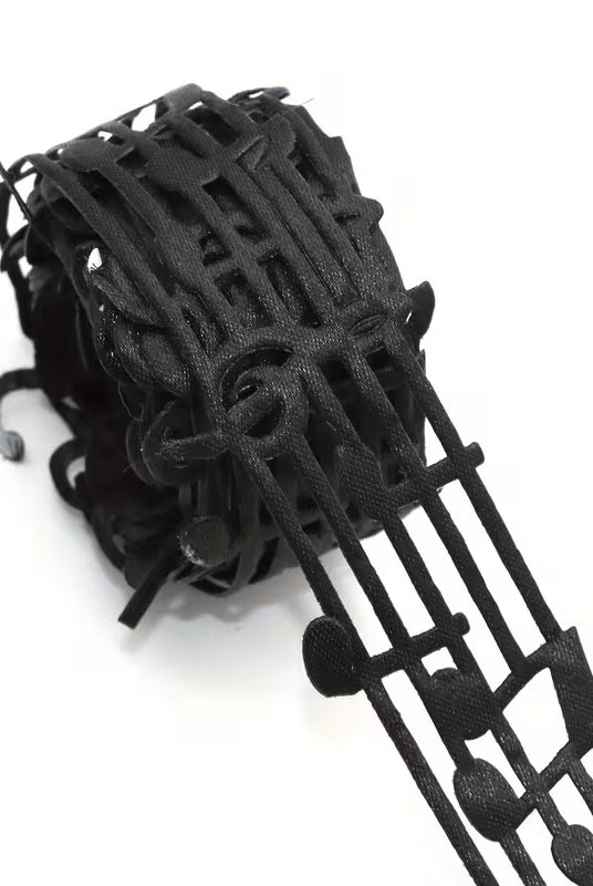 Close-up of black mesh ribbon featuring repeating music notes
