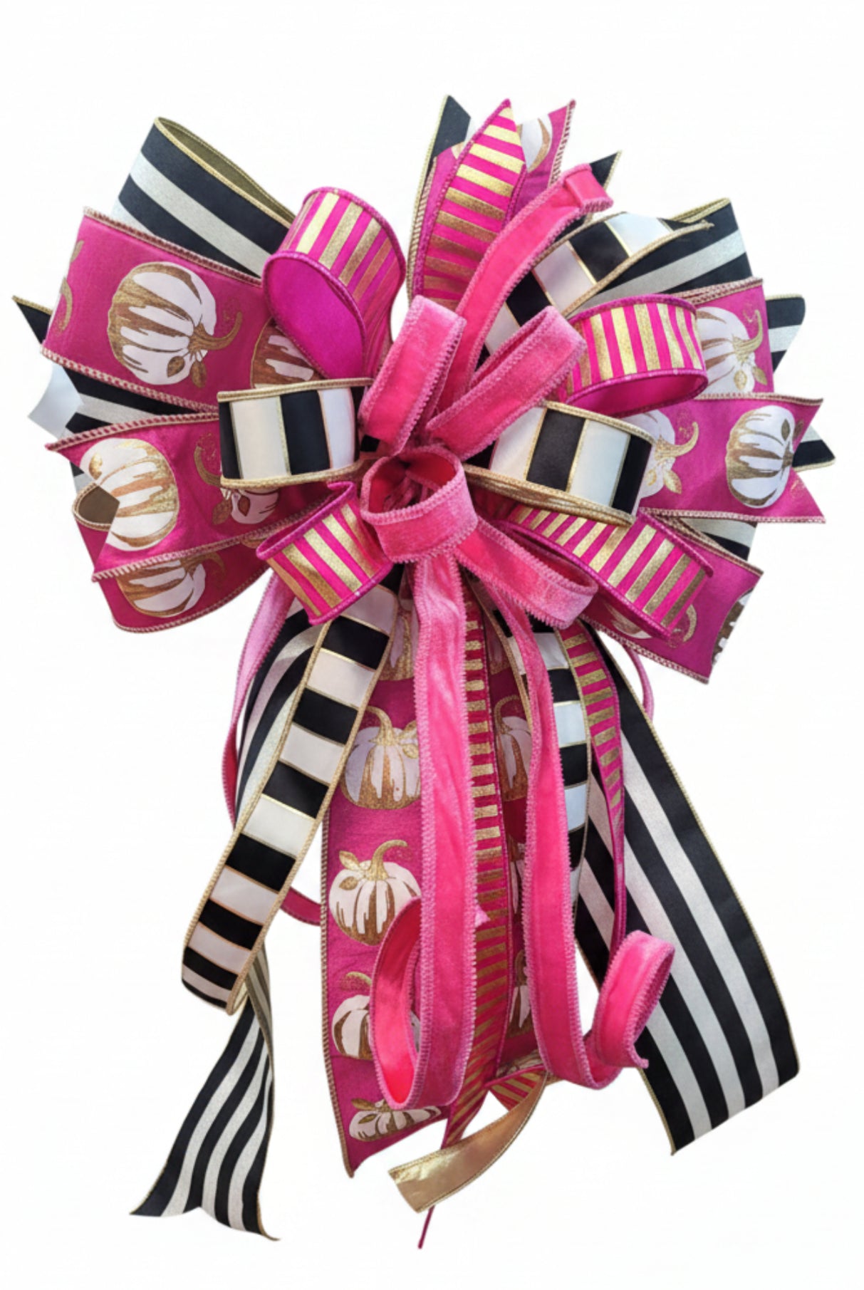 Large decorative fall bow featuring pink, white, and gold pumpkin patterns with black and white striped ribbon accents.