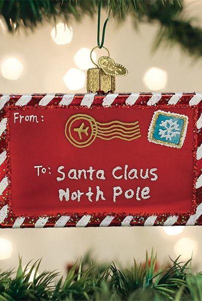 Red glass ornament shaped like a letter to Santa with white and red striped borders, gold postmark, and snowflake stamp.