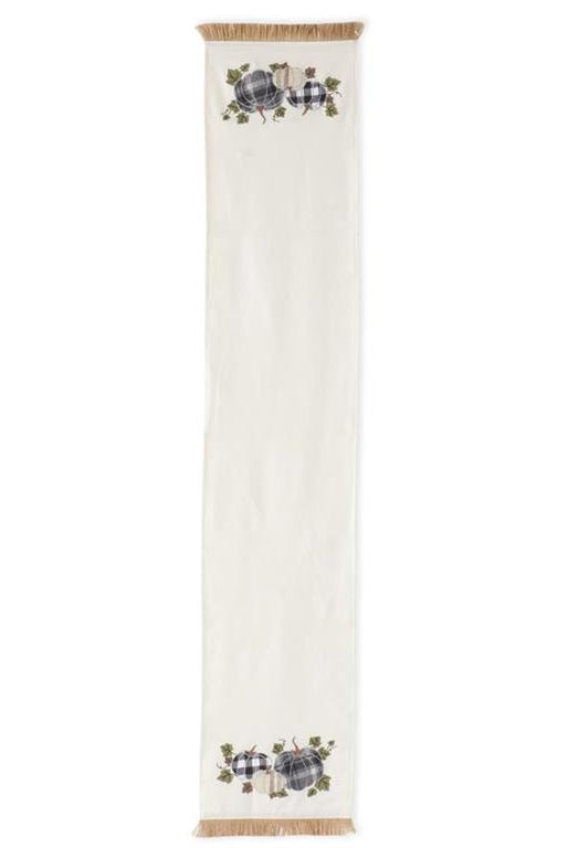 72-inch cream canvas table runner featuring plaid pumpkin appliques and rustic jute fringe ends.