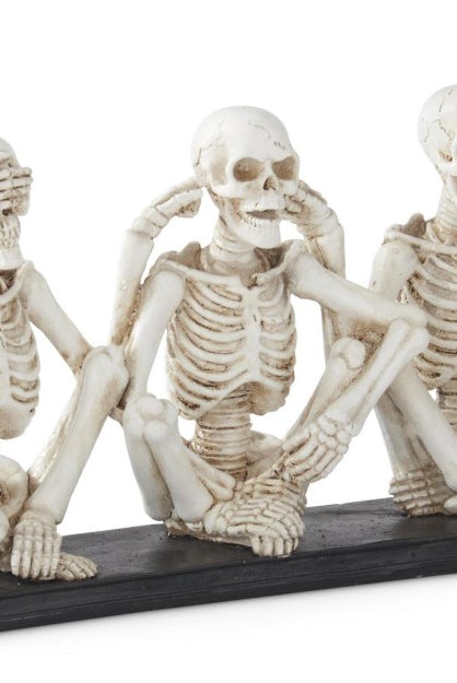 11.25-inch resin skeleton trio sitting on a black base, depicting the see, hear, and speak no evil proverb.