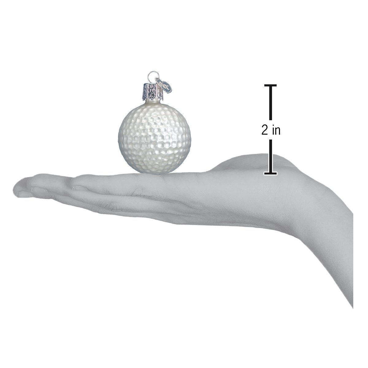 White glass golf ball Christmas ornament held in a hand, measuring 2 inches in height with a silver hanging cap.