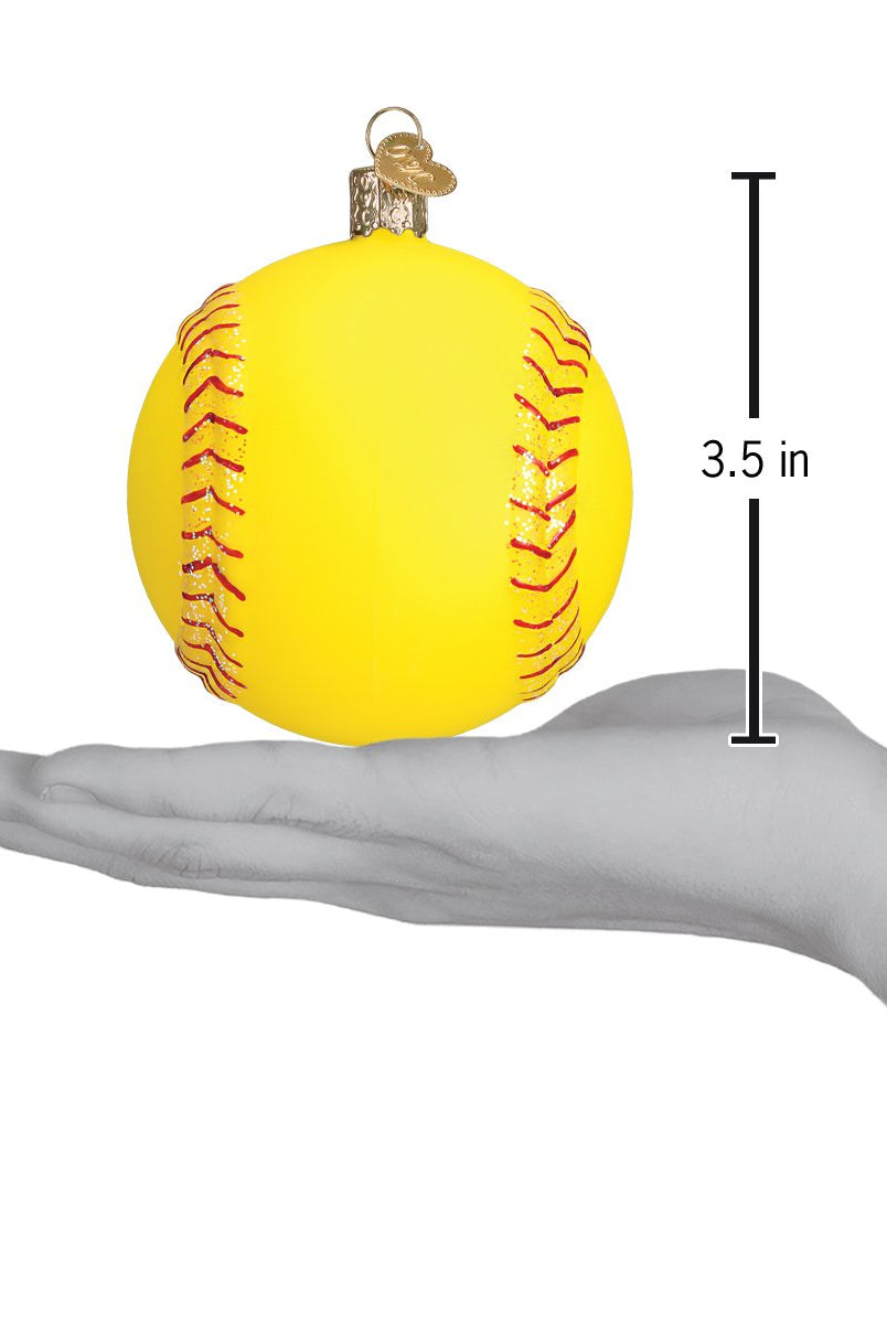 Yellow 3.5-inch softball Christmas ornament with red glitter stitching held in a hand.