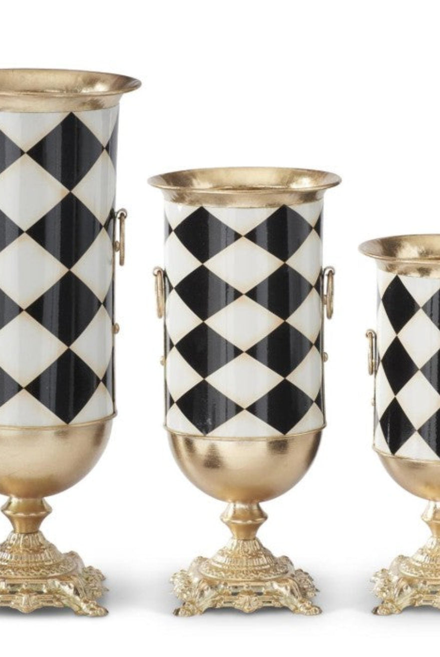 Three urn-style vases in small, medium, and large sizes featuring a black and white harlequin pattern with gold accents.