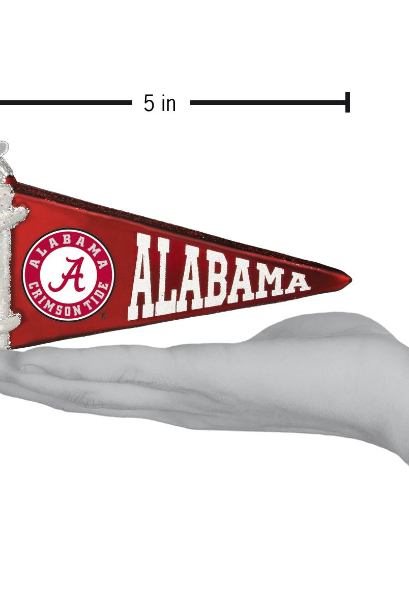5-inch red glass Alabama Crimson Tide pennant ornament with white logo and lettering held in a hand.