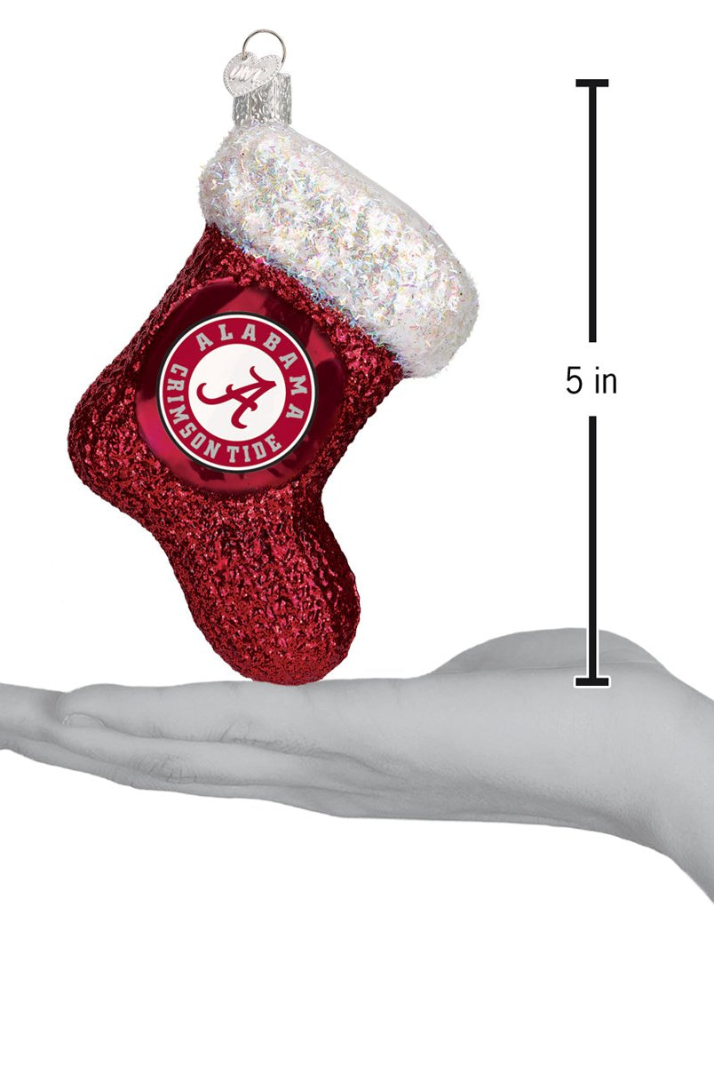 5-inch red glittery Alabama Crimson Tide stocking ornament with a white iridescent cuff held in a hand.