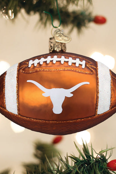 Burnt orange glass football ornament featuring the white Texas Longhorns logo and glittery white stripes.