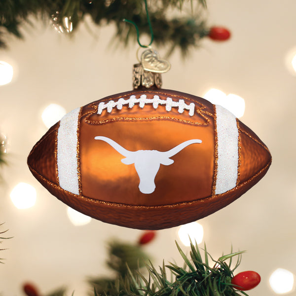 Burnt orange glass football ornament featuring the white Texas Longhorns logo and glittery white stripes.