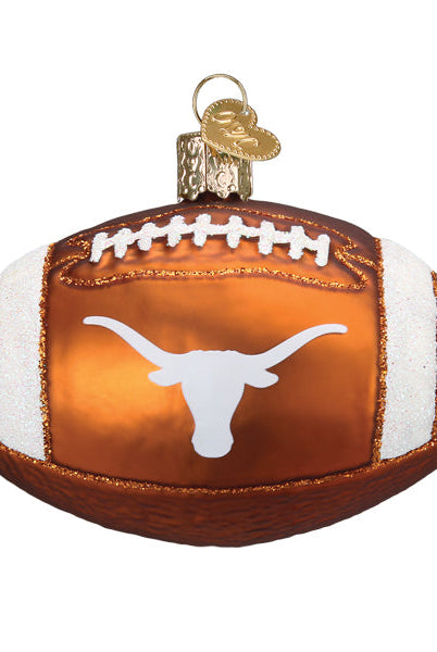 Burnt orange glass football ornament featuring a white Texas Longhorns logo and glittery white stripes.
