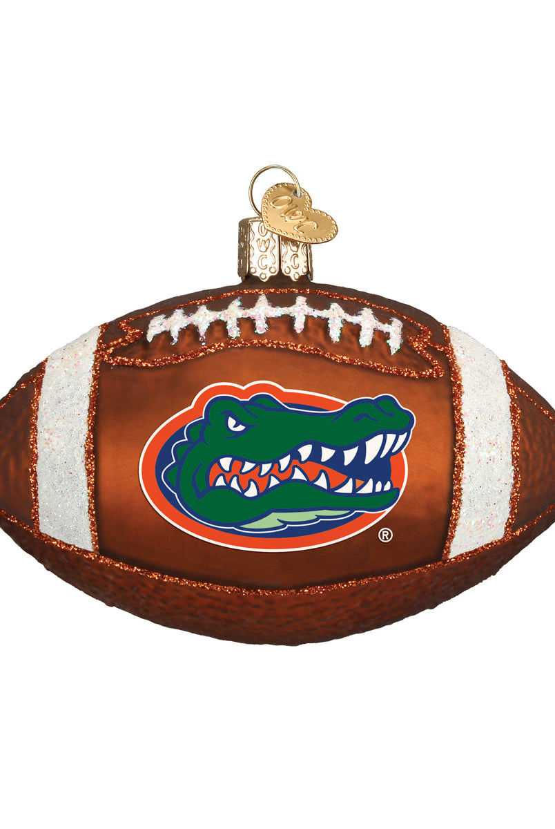 Glass Florida Gators football ornament featuring a brown textured finish, white glitter laces, and the team logo.