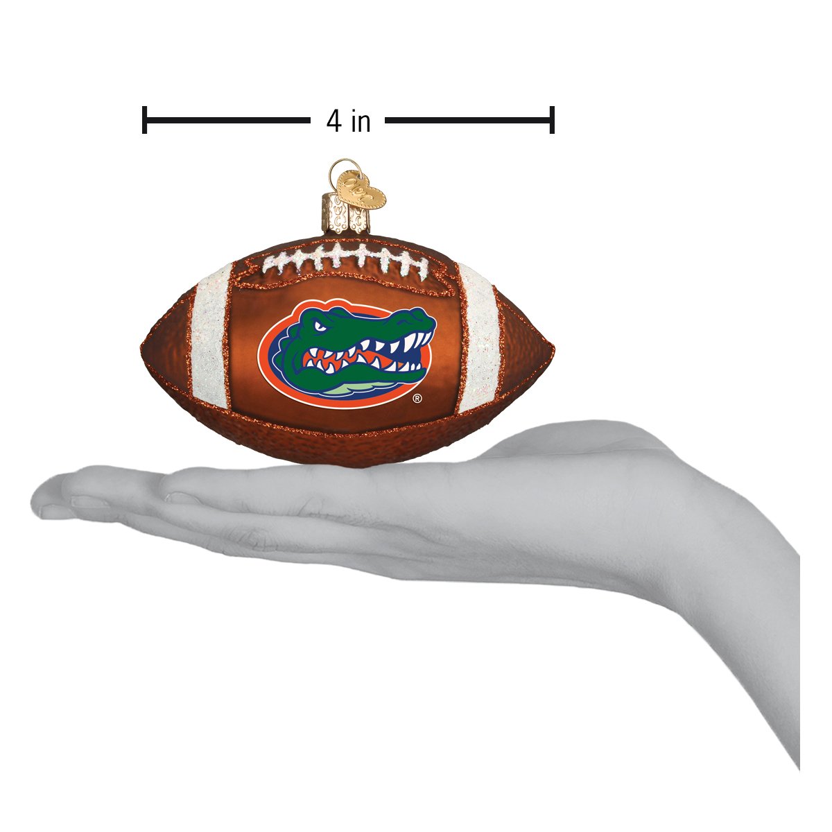 4-inch brown glass Florida Gators football ornament with white laces and team logo, held in a hand.