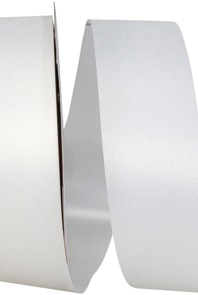Unspooling white jewel dust ribbon on cardboard core