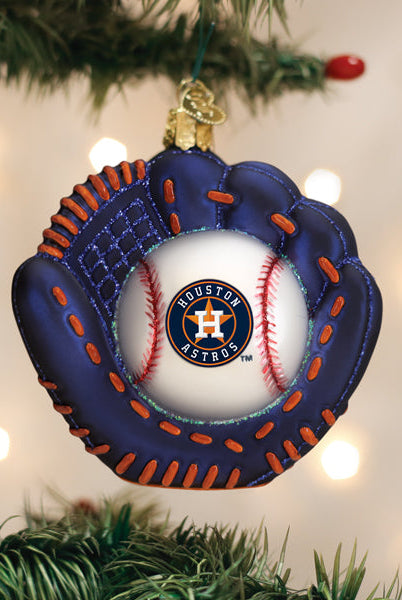 Navy blue baseball mitt ornament with orange stitching and a Houston Astros logo baseball center, hanging on a tree.