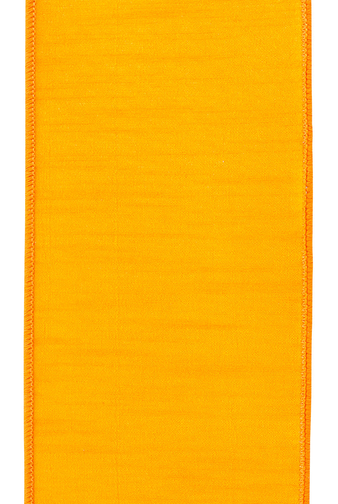 4-inch wide orange velvet ribbon with a textured finish and stitched edges for craft and gift wrapping projects.