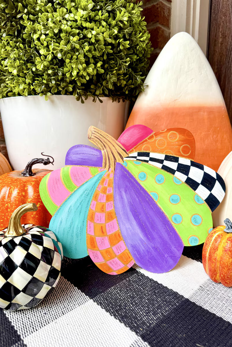 Small decorative pumpkin stake featuring colorful, patterned sections in bright purple, teal, lime green, and orange.