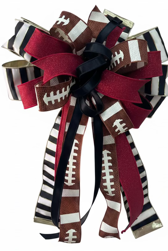 Large red and black football-themed bow with glitter accents, striped ribbon, and long tails for sports decor.