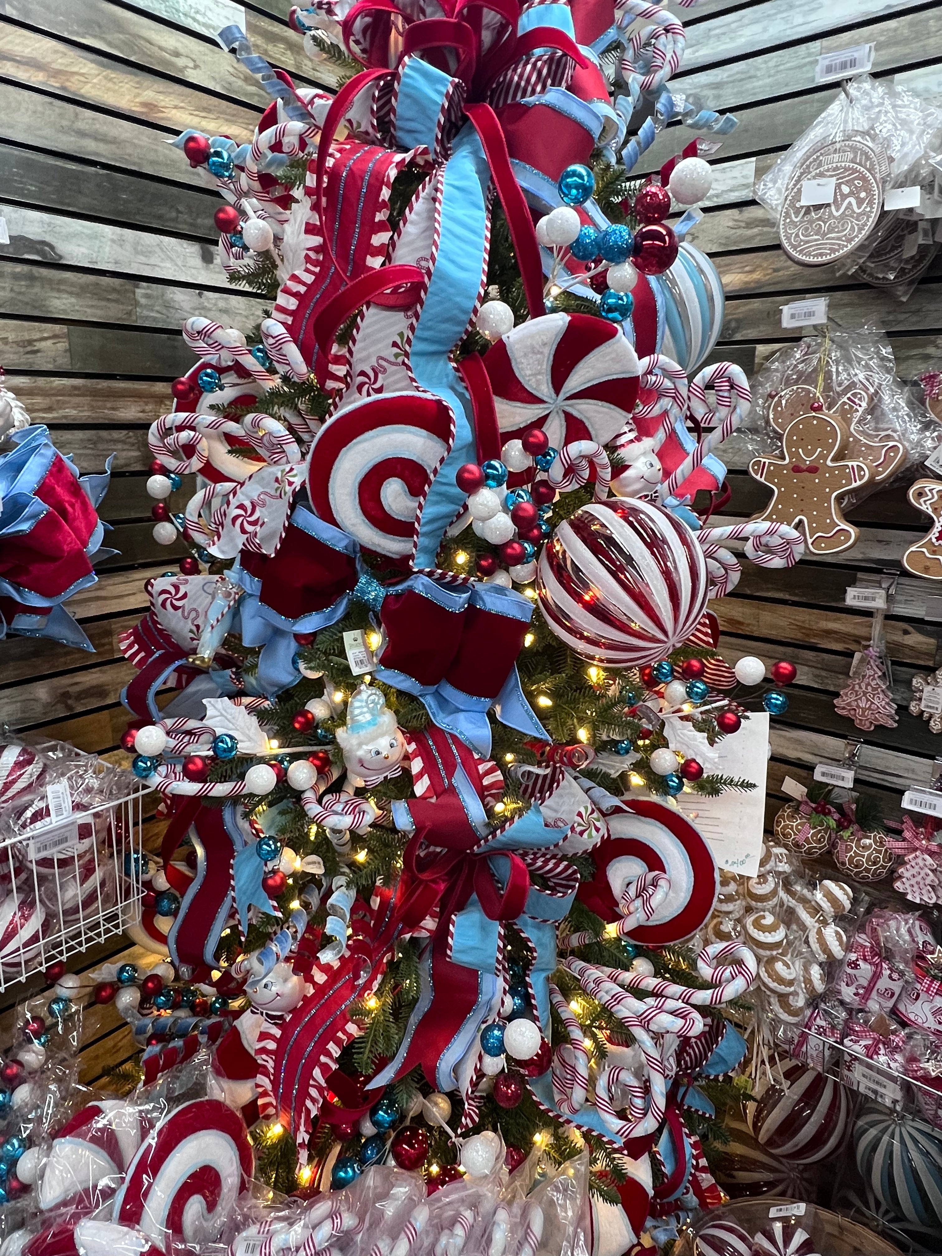 Red, white, and ice blue peppermint ornaments on Christmas tree