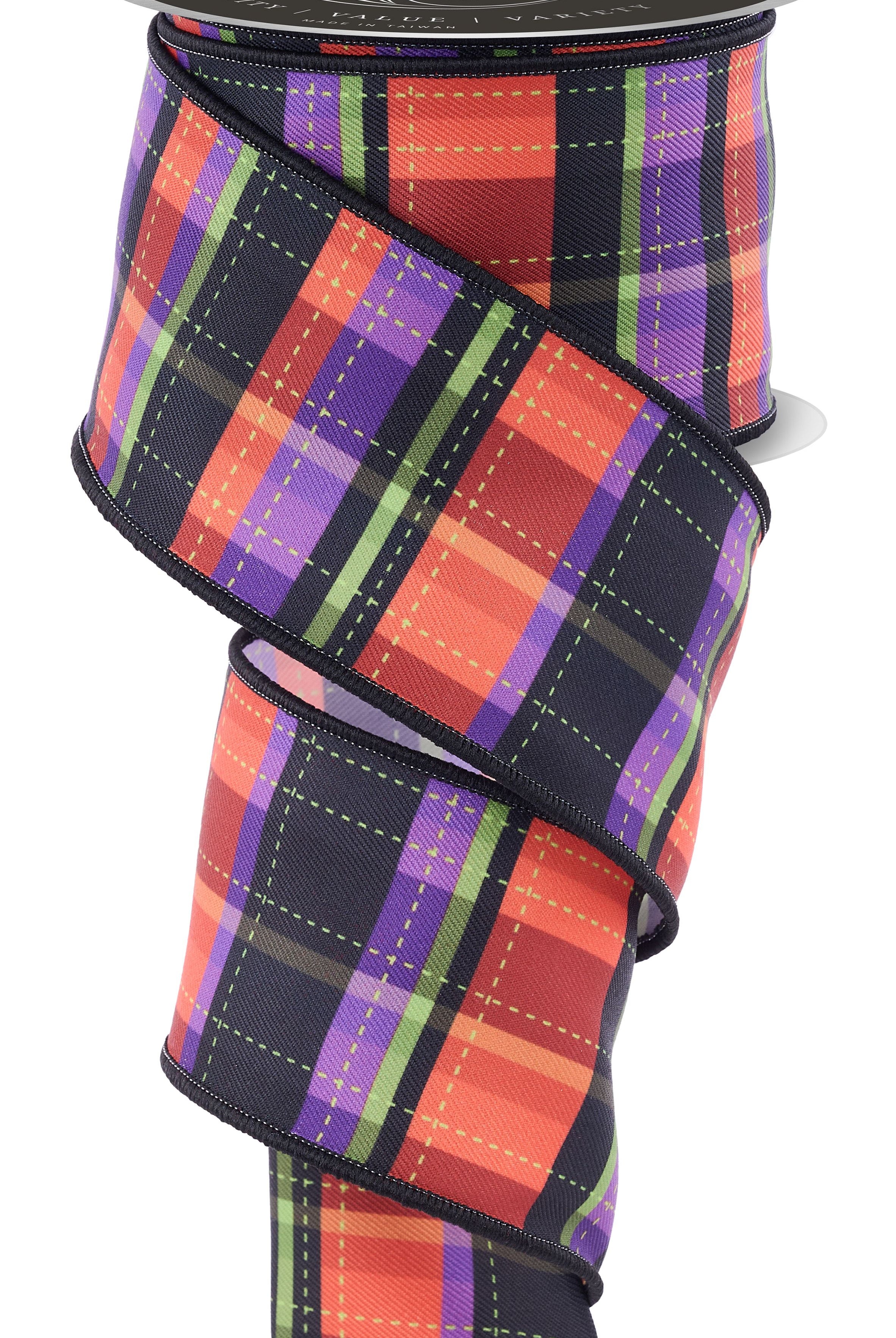 2.5-inch wired ribbon roll featuring a dashed plaid pattern in orange, black, and purple on a diagonal weave fabric.