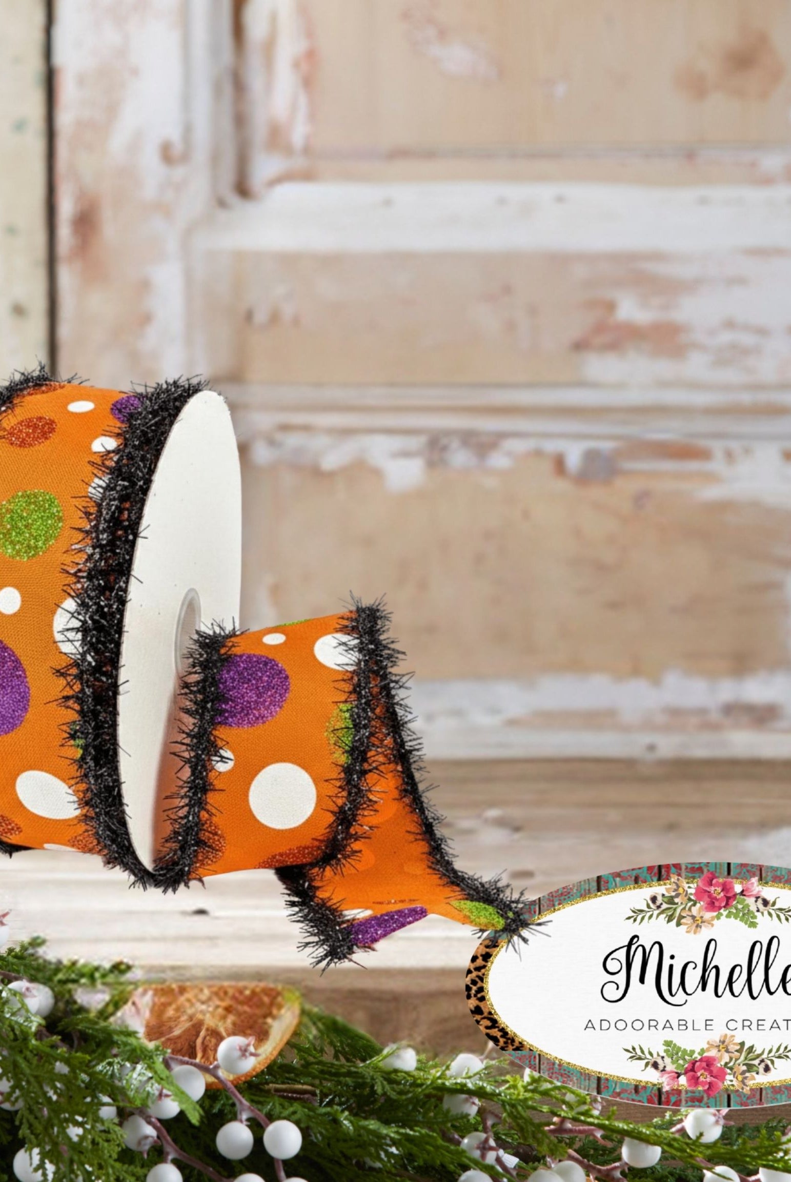 1.5-inch orange Halloween ribbon with colorful polka dots and black tinsel edges on a spool.