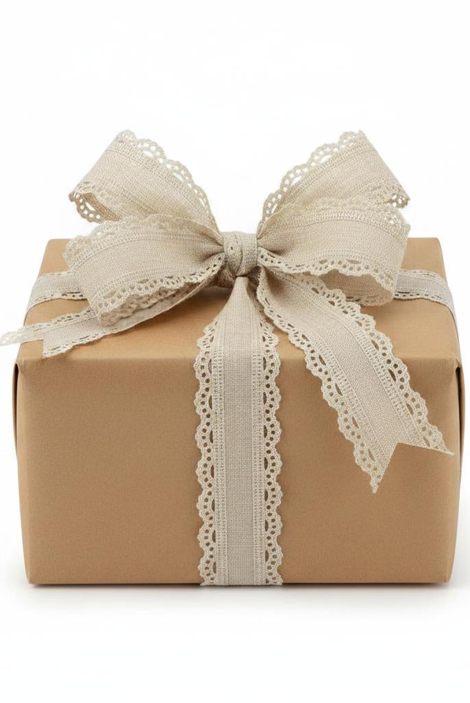 1.5-inch buff-colored ribbon with a delicate scalloped wired edge tied in a bow around a brown gift box.