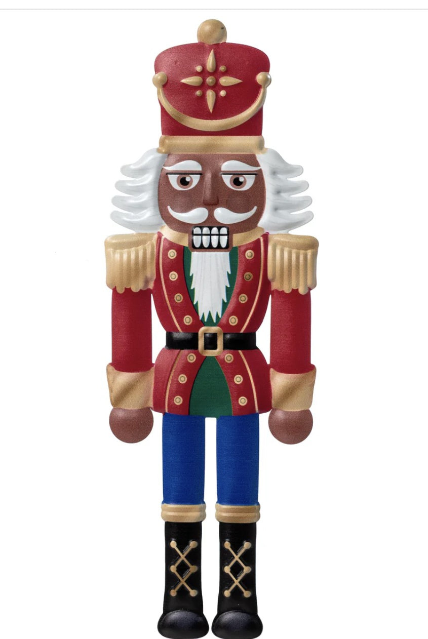 12-inch embossed metal nutcracker sign featuring a dark skin soldier in a red, gold, and blue uniform.