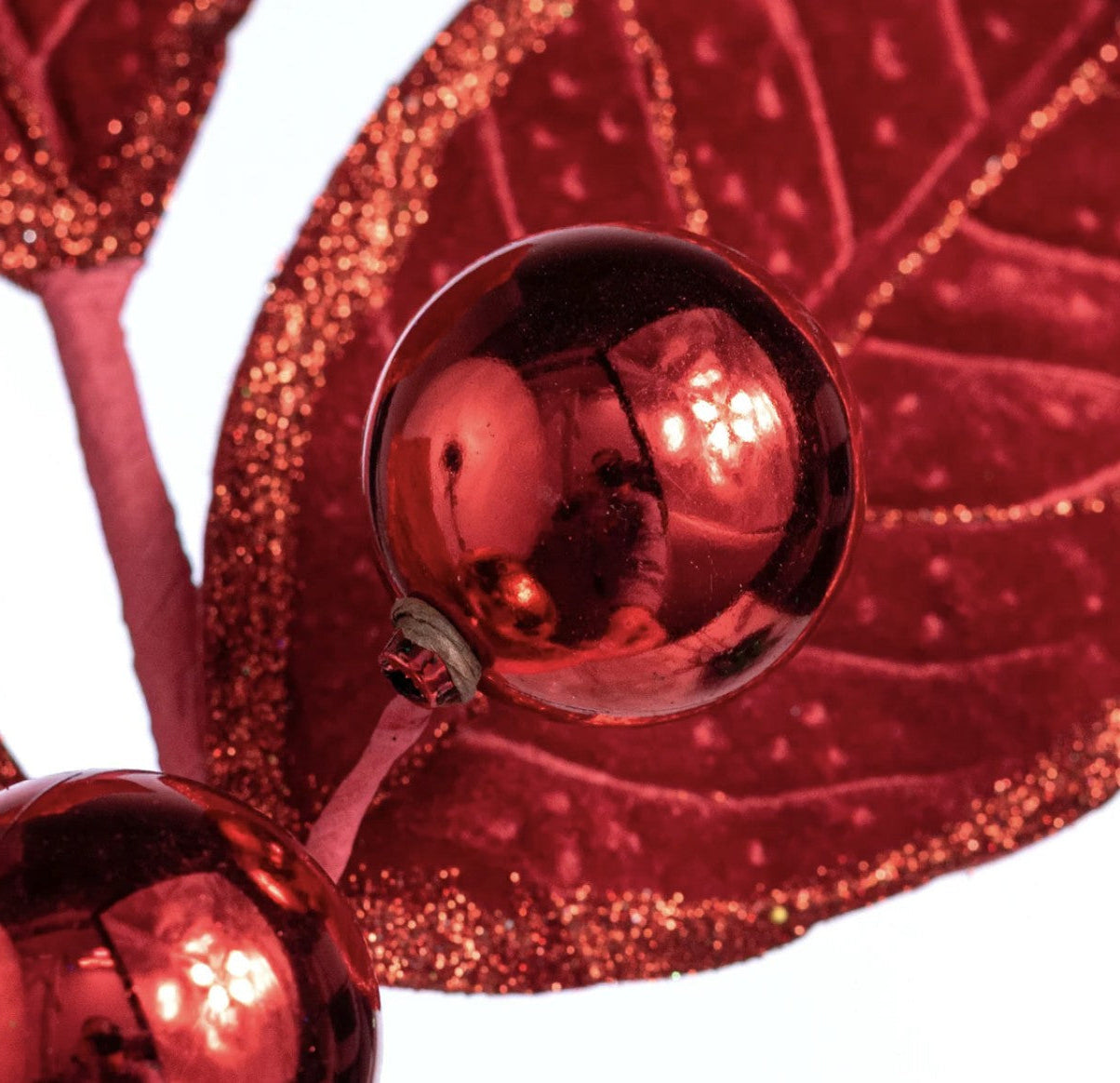 Red velvet holly spray with glitter-edged fabric leaves and two shiny metallic red berries on wired stems.