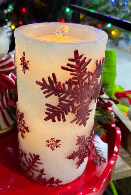 7.75-inch white wax LED pillar candle with shimmering red snowflake patterns and a bubbling water fountain effect.