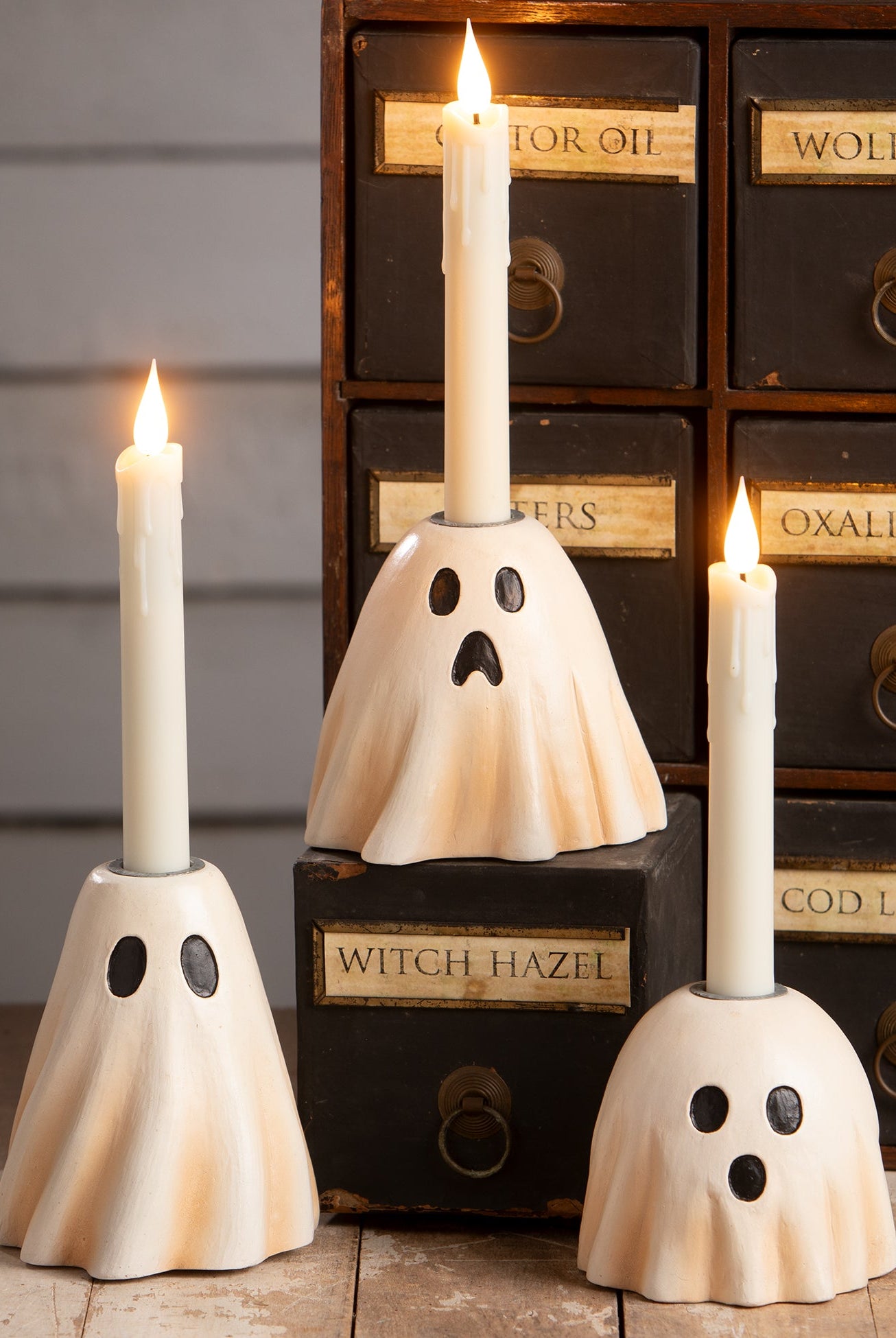 Bethany Lowe hand-painted resin ghost candlesticks in cream with black facial features, perfect for vintage Halloween decor.