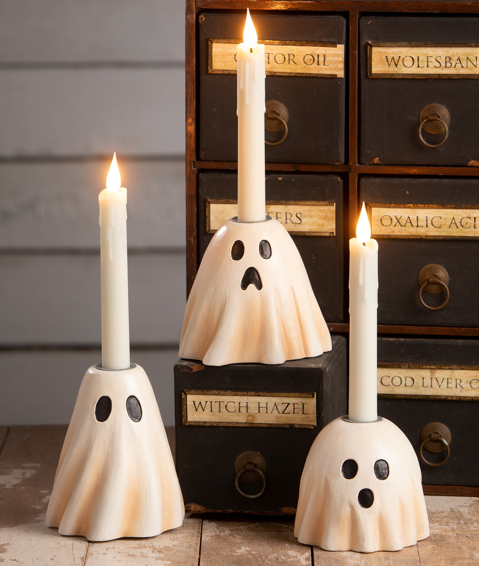 Bethany Lowe hand-painted resin ghost candlesticks in cream with black facial features, perfect for vintage Halloween decor.