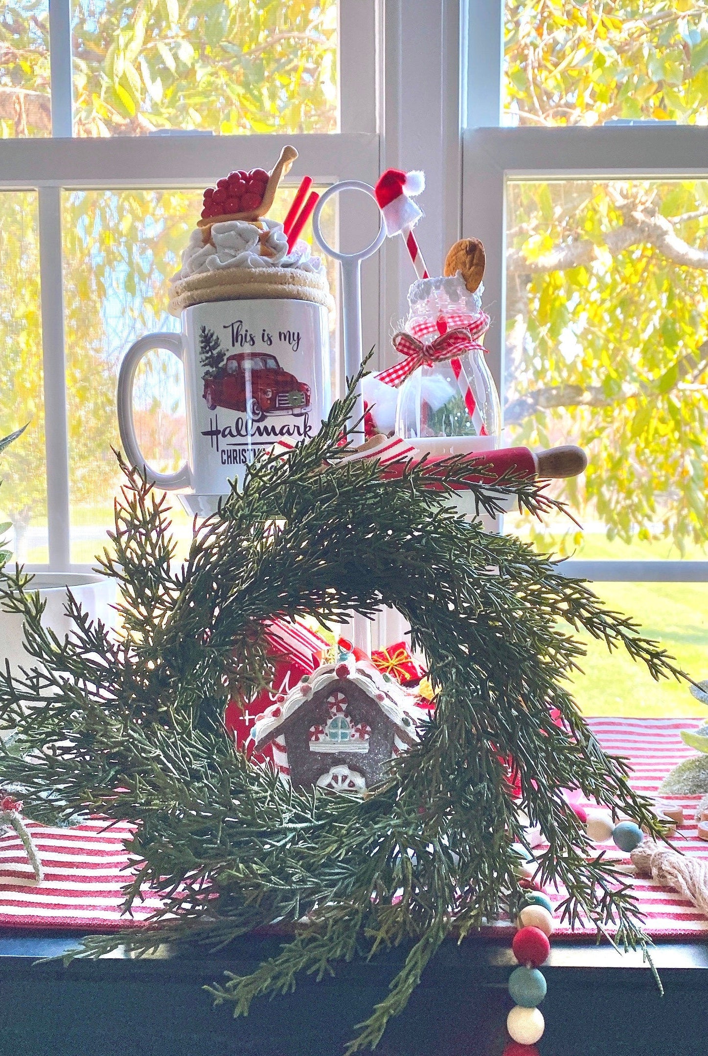 14-inch faux cedar mini Christmas wreath with realistic green foliage, styled as farmhouse holiday decor on a window sill.