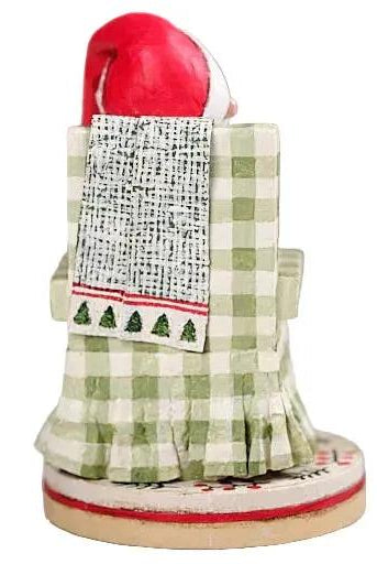 Lori Mitchell 7-inch poly resin Santa figurine sitting in a green checkered chair with a patterned throw blanket.