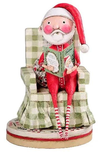 Lori Mitchell 7-inch Santa figurine in a green checkered chair reading a book, hand-painted poly resin folk art style.