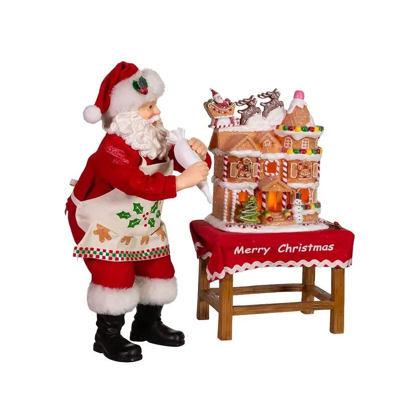 Shop For Kurt Adler 10.5" Fabriche Santa Decorating LED Gingerbread House Table Piece at Michelle's aDOORable Creations