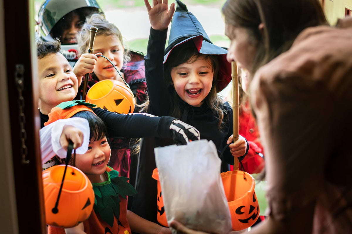 Kids in costume trick-or-treating. 