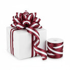 1.5-inch maroon and white striped satin wired ribbon on a spool and tied as a decorative bow on a white gift box.