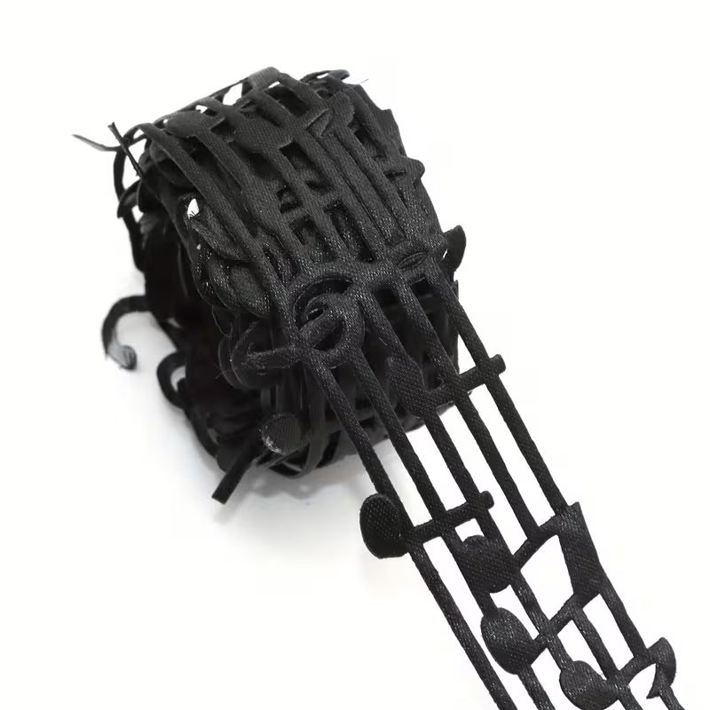 Close-up of black mesh ribbon featuring repeating music notes