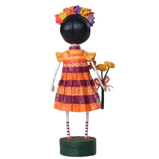 Lori Mitchell 7.5-inch poly resin Freida figurine with a striped dress, floral headpiece, and bouquet for Day of the Dead.
