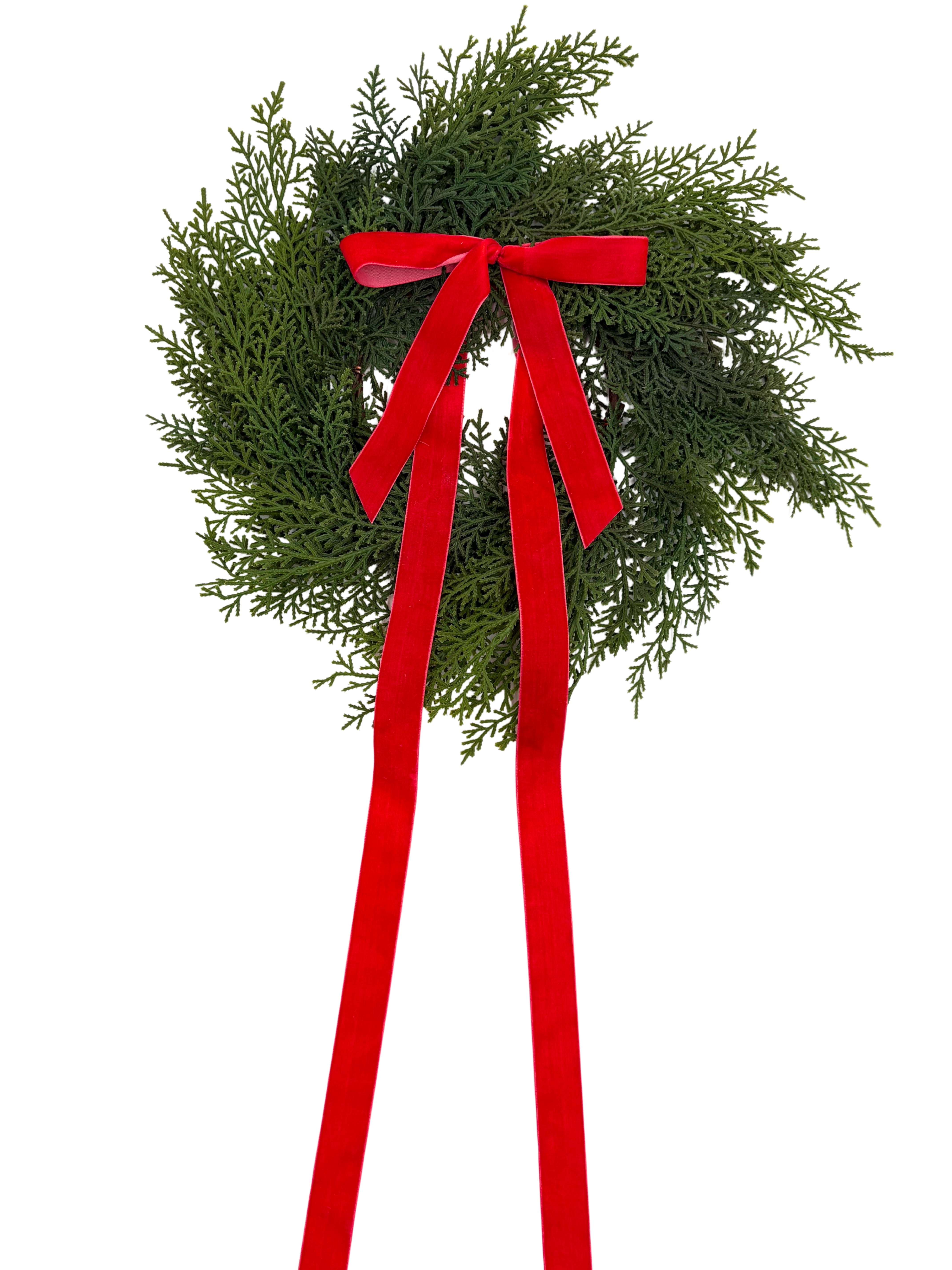 Mini faux cedar Christmas cabinet wreath featuring lush green foliage and a long, elegant red velvet ribbon bow.