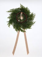 Mini faux cedar cabinet wreath with a rustic twig base and elegant caramel velvet ribbon on a white background.