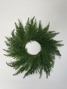 14-inch mini Christmas wreath made of realistic green faux cedar branches on a simple circular frame.