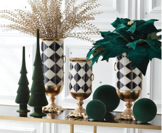 Black and white harlequin check urn vases with gold pedestal bases and side handles, styled with holiday florals.