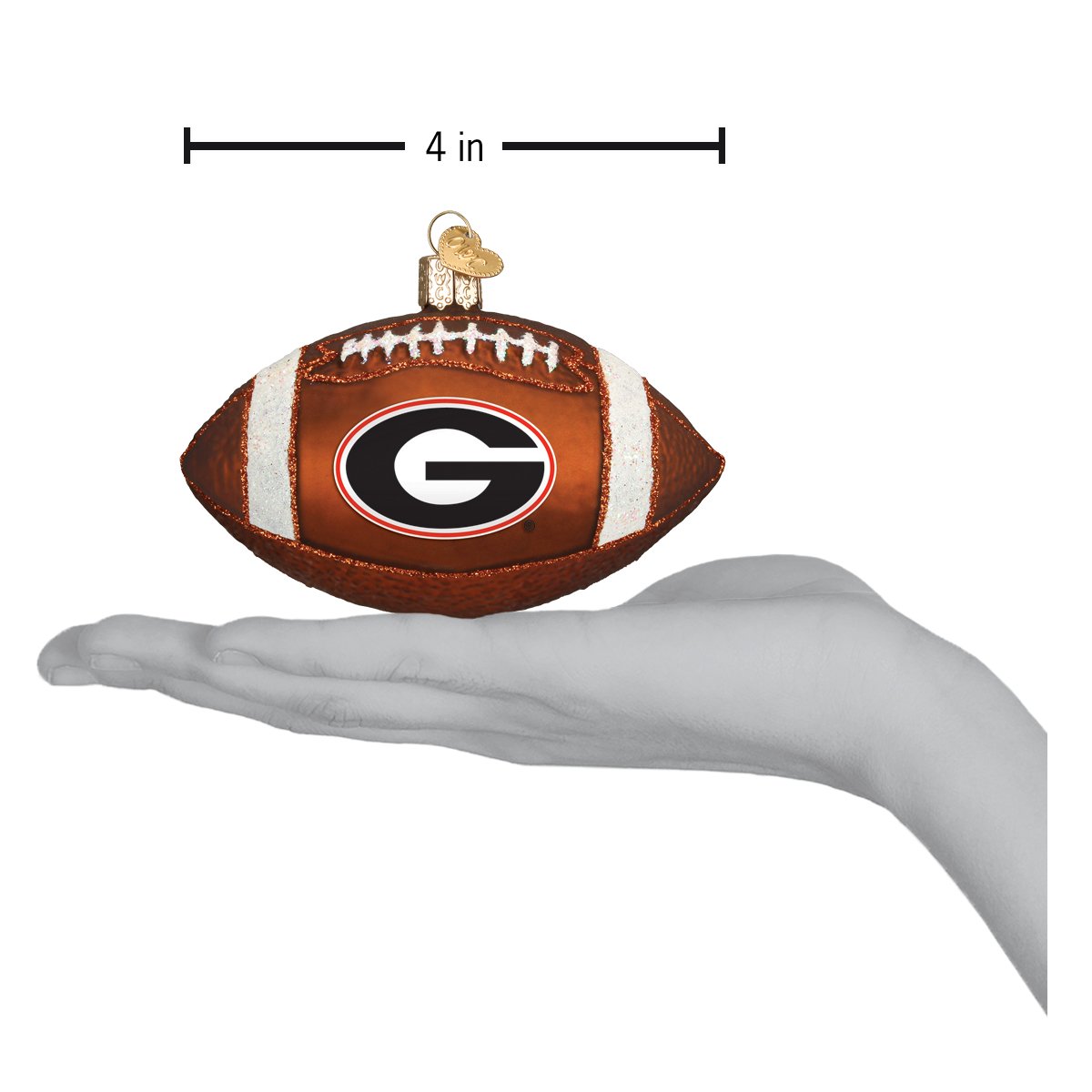 4-inch brown glass Georgia Bulldogs football ornament with white laces and team logo held in a hand.