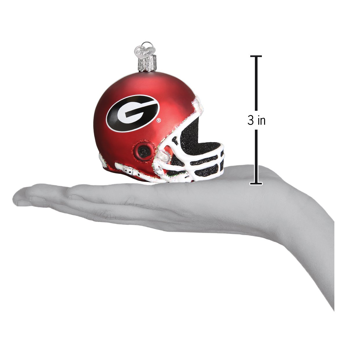 3-inch red Georgia Bulldogs glass football helmet ornament with black and white logo held in a hand.