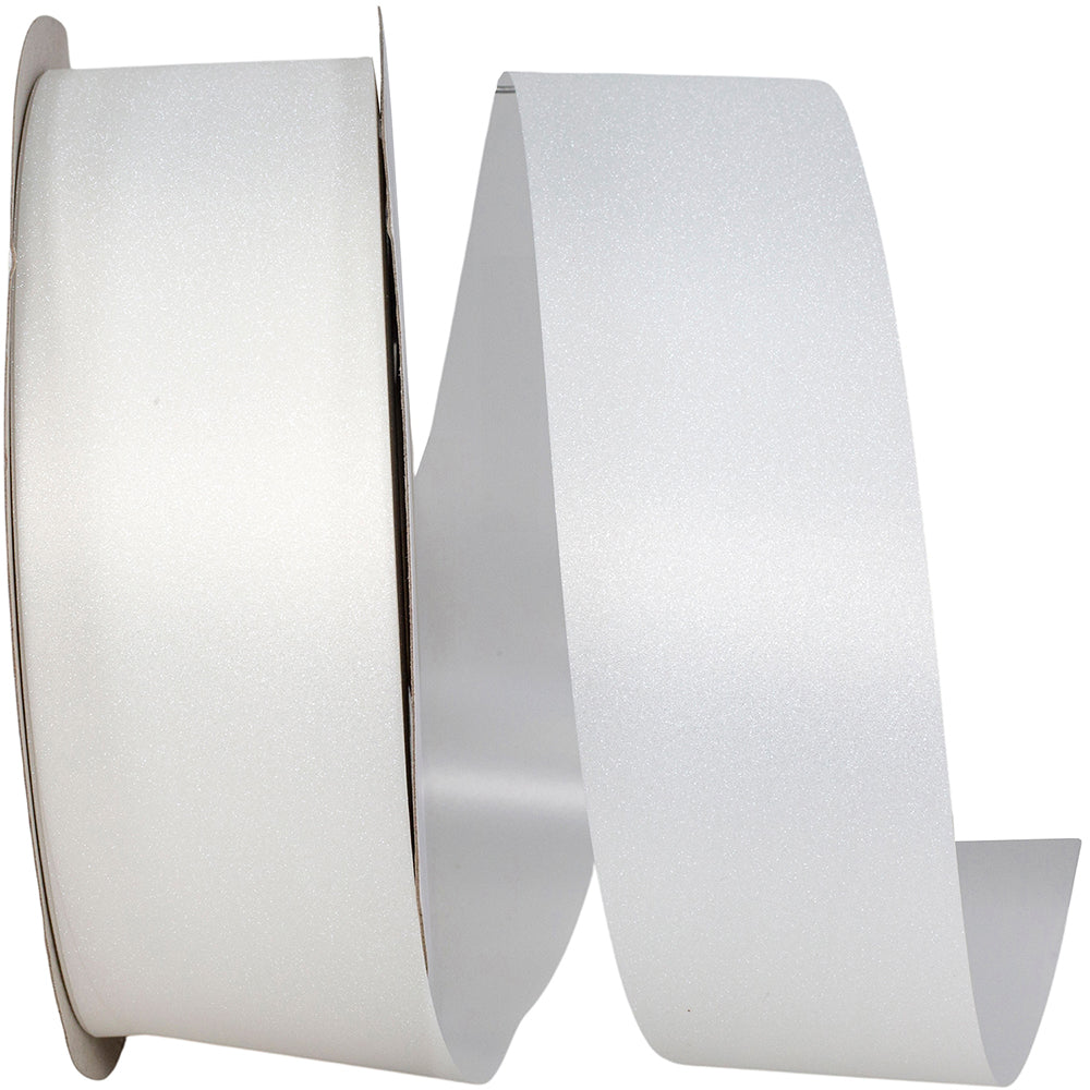 Unspooling white jewel dust ribbon on cardboard core