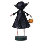 Back view of a 6-inch Veronica Vampire resin figurine wearing a black dress, striped stockings, and holding a pumpkin.