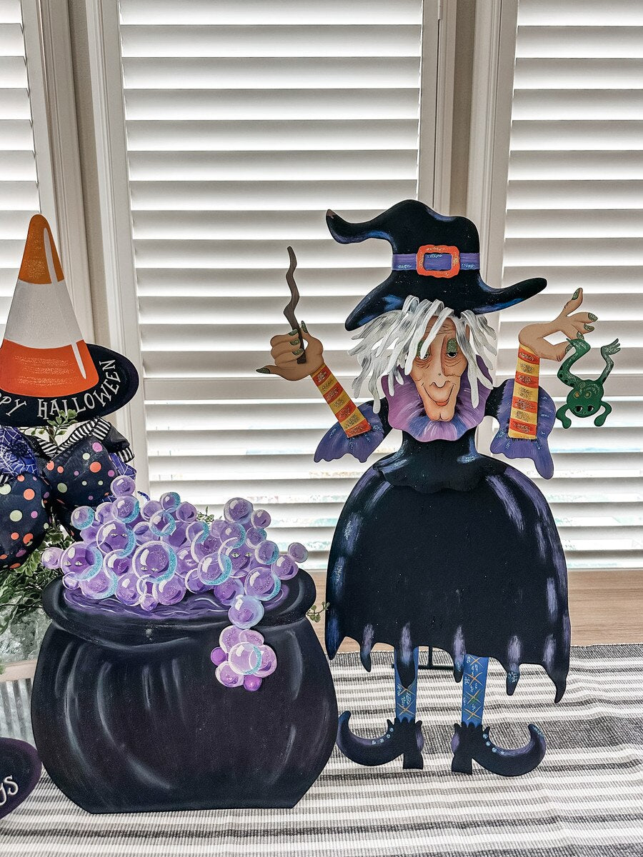 Tillie the Witch 24-inch metal Halloween decoration featuring a black dress, pointed hat, wand, and green frog.