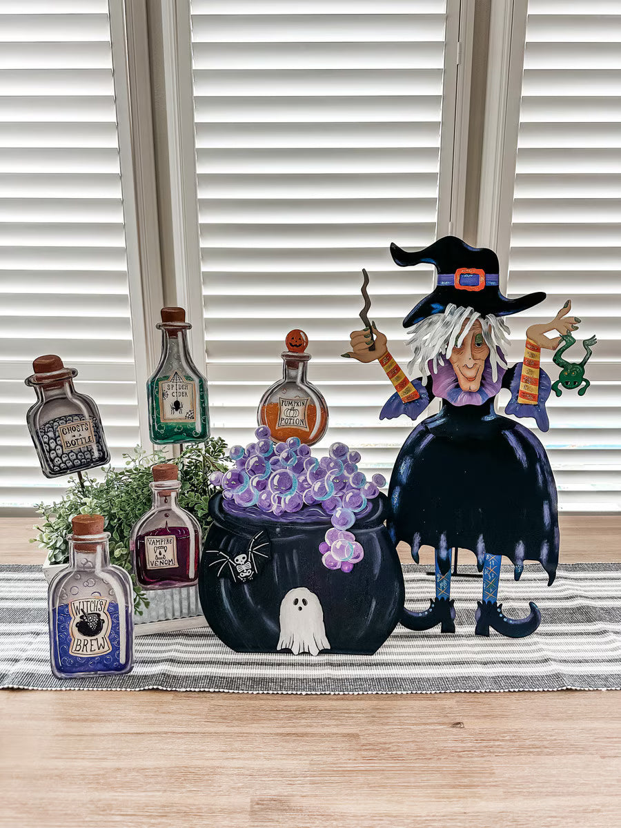 Tillie the Witch metal decor with a bubbling cauldron, potion bottles, and a frog, featuring whimsical hand-painted details.